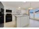 Modern kitchen with white cabinetry, granite countertops, and black appliances at 364 Dooley Dr, Henderson, NV 89015