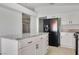 Bright kitchen featuring an island with granite counter top and black appliances at 364 Dooley Dr, Henderson, NV 89015