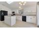 Clean kitchen with modern appliances, white cabinets and an island with granite countertop at 364 Dooley Dr, Henderson, NV 89015