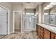 Bright bathroom features double sinks, walk-in shower, and neutral tile flooring at 3757 Via Geneva, Henderson, NV 89052