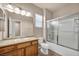Well-lit bathroom featuring a tub/shower, single sink vanity, and neutral finishes at 3757 Via Geneva, Henderson, NV 89052