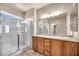 Bright bathroom features double sinks, walk-in shower, and neutral tile flooring at 3757 Via Geneva, Henderson, NV 89052