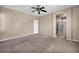 Spacious primary bedroom featuring neutral paint, carpet, ensuite bathroom and ceiling fan at 3757 Via Geneva, Henderson, NV 89052
