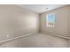 Neutral bedroom showcasing a window providing natural light to illuminate the carpeted floors at 3757 Via Geneva, Henderson, NV 89052