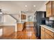 Open kitchen with wooden cabinets, granite countertops, and black appliances, seamlessly connected to living spaces at 3757 Via Geneva, Henderson, NV 89052