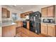 Well-appointed kitchen featuring wooden cabinets, granite countertops, and modern black appliances at 3757 Via Geneva, Henderson, NV 89052