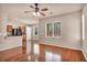 Open-concept living room featuring hardwood floors, a ceiling fan, and seamless flow into the kitchen at 3757 Via Geneva, Henderson, NV 89052