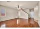 Spacious living room with hardwood floors, ceiling fan, neutral tones, and stairway to upper level at 3757 Via Geneva, Henderson, NV 89052