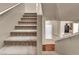 Carpeted staircase featuring neutral paint and wrought iron railing at 3757 Via Geneva, Henderson, NV 89052