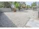Spacious gravel backyard with mature trees, enclosed by a block wall, offering a serene outdoor space at 4269 Roanridge Ave, Las Vegas, NV 89120