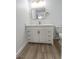 Bathroom vanity with white cabinets, gold hardware, white marble countertop and gold framed mirror at 4269 Roanridge Ave, Las Vegas, NV 89120