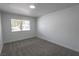 A bright, neutral bedroom offers cozy gray carpeting and plenty of natural light at 4269 Roanridge Ave, Las Vegas, NV 89120
