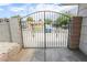 Ornamental iron driveway gate with privacy wall at 4269 Roanridge Ave, Las Vegas, NV 89120