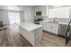 Bright kitchen with modern white cabinetry, stainless appliances, and a large center island at 4269 Roanridge Ave, Las Vegas, NV 89120