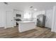Modern kitchen with stainless steel appliances, white cabinetry, and marble countertops at 4269 Roanridge Ave, Las Vegas, NV 89120