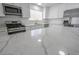 Modern kitchen features white cabinets, stainless steel appliances, and a marble countertop island at 4269 Roanridge Ave, Las Vegas, NV 89120