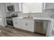 Well-lit kitchen with stainless steel appliances, marble counters, and white cabinets at 4269 Roanridge Ave, Las Vegas, NV 89120