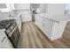 Modern kitchen with stainless steel appliances, white cabinets and island with a marble countertop at 4269 Roanridge Ave, Las Vegas, NV 89120