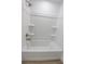 Clean white shower with built-in shelves and bronze fixtures with a tub at 4269 Roanridge Ave, Las Vegas, NV 89120