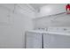 Bright laundry room with a washer and dryer and wire shelving at 4400 S Jones Blvd # 1125, Las Vegas, NV 89103