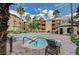 Beautiful community pool area with comfortable lounge chairs, palm trees and building views at 4400 S Jones Blvd # 1125, Las Vegas, NV 89103