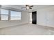Bedroom featuring neutral carpet, a ceiling fan, and a modern barn door at 532 Monarch Ridge Ct, North Las Vegas, NV 89084