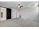 Neutral bedroom with carpet, ceiling fan and a barn door leading to a bathroom at 532 Monarch Ridge Ct, North Las Vegas, NV 89084
