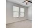 A neutral bedroom with carpeted floors and large windows at 532 Monarch Ridge Ct, North Las Vegas, NV 89084