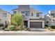 Stunning two-story home featuring modern architecture, a lush front yard, and a two car garage at 532 Monarch Ridge Ct, North Las Vegas, NV 89084