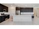 Spacious kitchen featuring stainless steel appliances, gas range, and sleek white countertops at 532 Monarch Ridge Ct, North Las Vegas, NV 89084