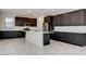 Spacious kitchen featuring dark wood cabinetry, stainless steel appliances, and a white center island at 532 Monarch Ridge Ct, North Las Vegas, NV 89084