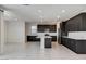 Full view of the open kitchen with dark wood cabinets, white countertops, and recessed lighting at 532 Monarch Ridge Ct, North Las Vegas, NV 89084