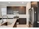 Close-up showcasing a kitchen island, stainless steel appliances, and dark wood cabinets at 532 Monarch Ridge Ct, North Las Vegas, NV 89084