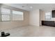 Bright living room featuring tile floors, neutral walls, and large windows offering ample natural light at 532 Monarch Ridge Ct, North Las Vegas, NV 89084
