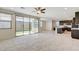 Open living area with tiled floors, sliding glass doors, and an adjacent modern kitchen at 532 Monarch Ridge Ct, North Las Vegas, NV 89084