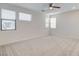 Loft with bright natural light from multiple windows, neutral carpet, and a ceiling fan at 532 Monarch Ridge Ct, North Las Vegas, NV 89084