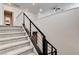 Carpeted staircase with modern, linear railing in a home with white walls and neutral decor at 532 Monarch Ridge Ct, North Las Vegas, NV 89084