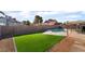 Private backyard boasts artificial grass and refreshing swimming pool at 5570 Palm St, Las Vegas, NV 89120