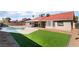 Spacious backyard features a pool, covered patio, and well-maintained lawn at 5570 Palm St, Las Vegas, NV 89120