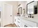 Bright bathroom boasts dual sinks, black hardware, and stylish mirrors for a modern touch at 5570 Palm St, Las Vegas, NV 89120