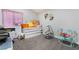 Bedroom showcasing a bed, storage and baby swing; offering a cozy and functional space at 5570 Palm St, Las Vegas, NV 89120