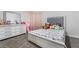 Well-lit bedroom includes a bed, dresser, and accent mirror with a comfortable and inviting feel at 5570 Palm St, Las Vegas, NV 89120