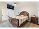 Comfortable bedroom features wood furniture, a ceiling fan and a TV for relaxing evenings at 5570 Palm St, Las Vegas, NV 89120