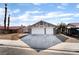 Charming single-story home with a two-car garage, desert landscaping, and a red-tiled roof at 5570 Palm St, Las Vegas, NV 89120
