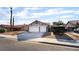 Charming single-story home with a two-car garage, desert landscaping, and a red-tiled roof at 5570 Palm St, Las Vegas, NV 89120
