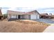 Charming single-story home with a two-car garage, desert landscaping, and a red-tiled roof at 5570 Palm St, Las Vegas, NV 89120