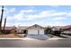 Charming single-story home with a two-car garage, desert landscaping, and a red-tiled roof at 5570 Palm St, Las Vegas, NV 89120