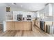 Bright kitchen features white cabinets, stainless steel appliances, and an island at 5570 Palm St, Las Vegas, NV 89120