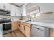 Bright kitchen features stainless steel appliances, and white cabinets at 5570 Palm St, Las Vegas, NV 89120