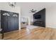 Inviting living room with wood floors, modern fireplace feature, and natural light from the bay window at 5570 Palm St, Las Vegas, NV 89120